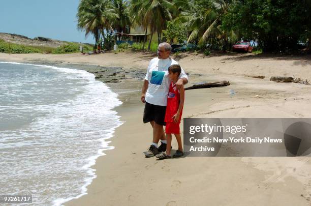 Ronaldo Martinez, who stars in a series of graphic anti-smoking television ads, walks along the beach with his cousin's son, Luis Rivera, in his...