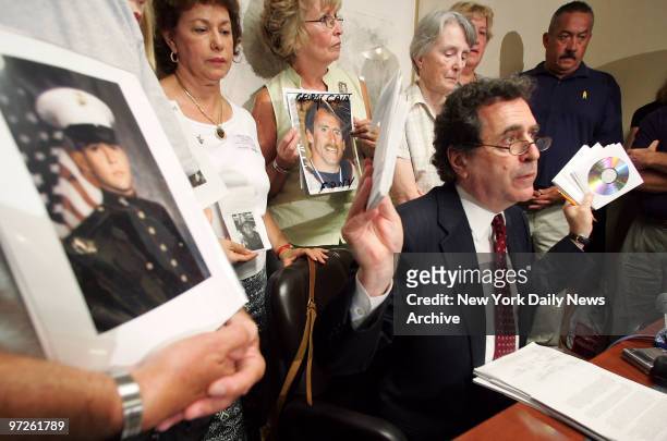 Civil rights attorney Norman Siegel is joined by families of victims of the World Trade Center attacks on 9/11 as he holds up copies of CD's...