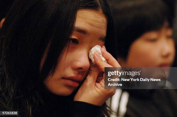 Mourner weeps during a traditional Buddhist funeral service for Stuyvesant High School freshman April Lao at the Chun Fook Funeral Home in Flushing,...