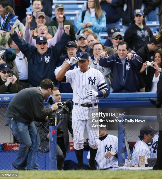Fans cheer as New York Yankees' Alex Rodriguez comes out of the dugout for an interview, after he hit a three-run, walk-off homer to center in the...