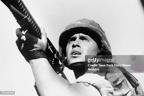 Lance Cpl. Jose L. Aguirre of Stockton, Calif., takes aim during offensive in Vecca Monte west of Panama City during Operation Just Cause, the name...