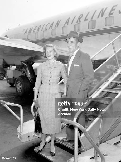 Humphrey Bogart and his missus, Lauren Bacall, alight from plane at International Airport. His next is "The Harder They Fall," a fight movie. They'll...