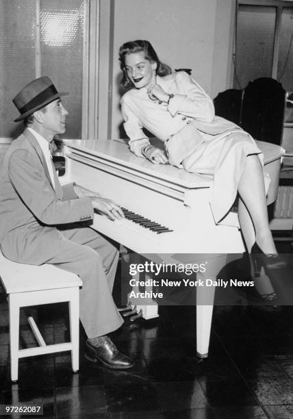 Humphrey Bogart and Lauren Bacall visit the Daily News. Humphrey Bogart plays a chord while Lauren Bacall sings a bar or two. They both posed in our...