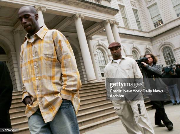 Larenzo Kindred and Jean Nelson walk away after attending a news conference on the steps of City Hall. The two men say they witnessed the shooting of...