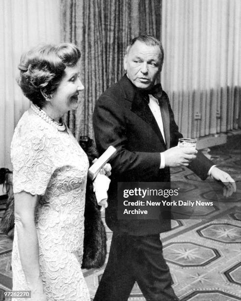 Claudette Colbert and Frank Sinatra exchange quips before dinner at the Americana Hotel for Jack Benny and George Burns Testimonial.