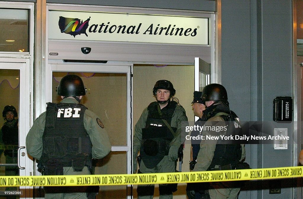 FBI SWAT team members gather in front of the National Airlin