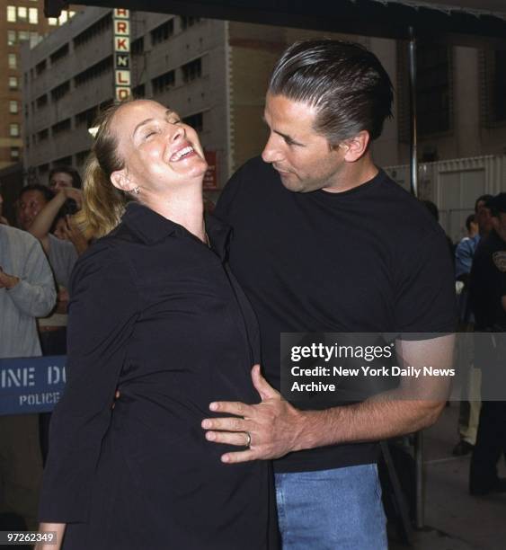 Billy Baldwin hugs pregnant wife Chynna Phillips as they arrive at Madison Square Garden to see the first of Madonna's five Drowned World Tour...