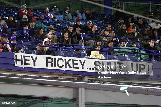 Fans hang a banner at Shea Stadium to let New York Mets' outfielder Rickey Henderson know how they feel about his continued sulking over his...