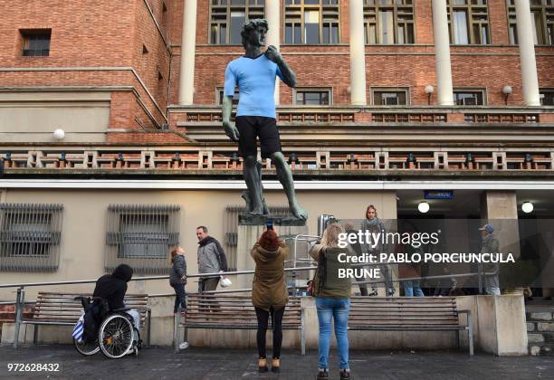 Replica of Michelangelo's David outside the Montevideo city council headquarters was dressed in the Uruguayan national football team uniform ahead of...