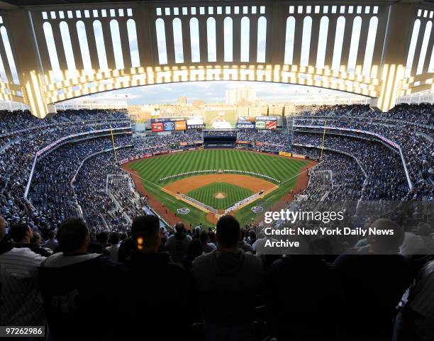 Fans stand for The National Anthem when the New York Yankees played the Minnesota Twins in game 1 of their ALDS at Yankee Stadium.,