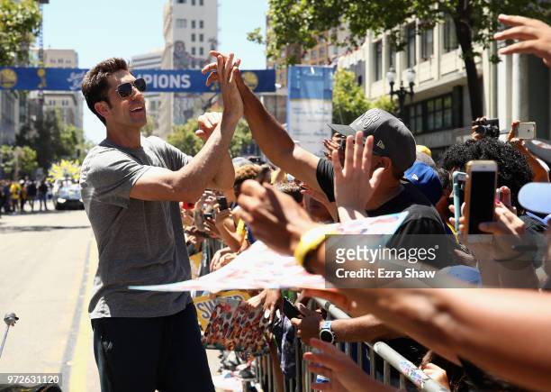 General manager Bob Myers of the Golden State Warriors celebrates with the crowd during the Golden State Warriors Victory Parade on June 12, 2018 in...