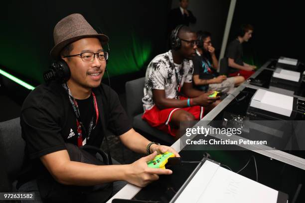 Game enthusiasts and industry personnel play 'Forza Horizon 4' during the Electronic Entertainment Expo E3 at the Microsoft Theater on June 12, 2018...