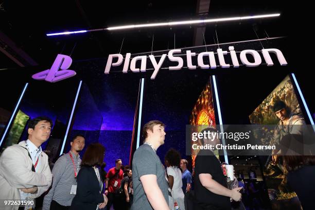 Game enthusiasts and industry personnel visit the 'Sony Playstation' exhibit during the Electronic Entertainment Expo E3 at the Los Angeles...