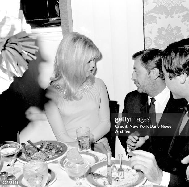 Birgitte Bardot and Robert Mitchum chat at a party for Bardot at the Beverly Hills Hotel.