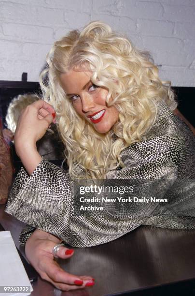 Model Anna Nicole Smith lounges around backstage during Lane Bryant's plus-size lingerie fashion show, held at Industria Superstudio.