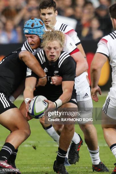 New-Zealand's center Scott Gregory is tackled during the U20 World Rugby union Championship semi-final match between France and New-Zealand at the...