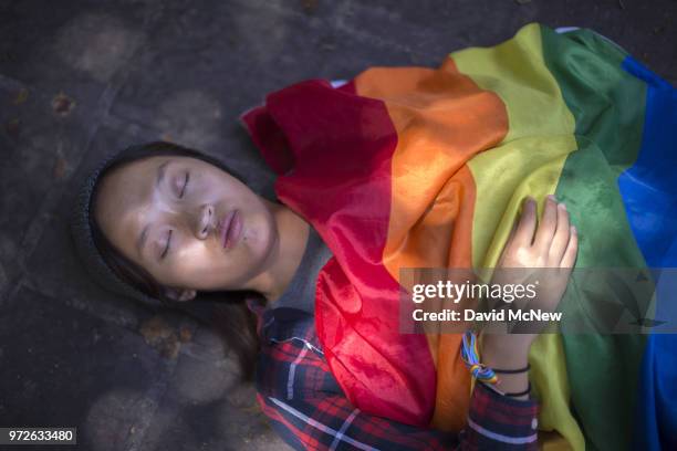 Woman participates in a "die-in" on the two-year anniversary of the Pulse nightclub mass shooting to remember the victims and call for an end to gun...