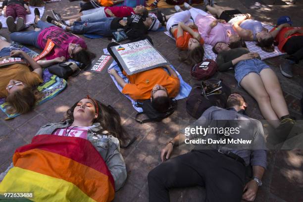 People participate in a "die-in" on the two-year anniversary of the Pulse nightclub mass shooting to remember the victims and call for an end to gun...