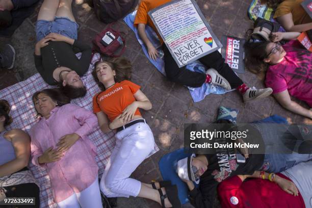 People participate in a "die-in" on the two-year anniversary of the Pulse nightclub mass shooting to remember the victims and call for an end to gun...