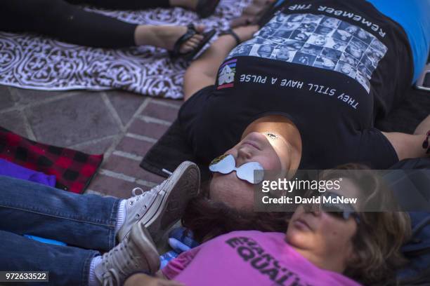 Tanya Witt participates in a "die-in" on the two-year anniversary of the Pulse nightclub mass shooting to remember the victims and call for an end to...