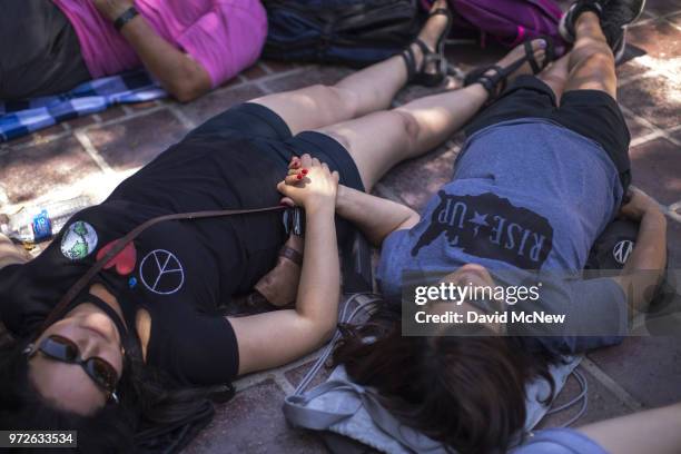 People participate in a "die-in" on the two-year anniversary of the Pulse nightclub mass shooting to remember the victims and call for an end to gun...