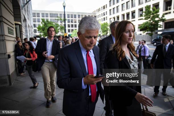 Daniel Petrocelli, lead attorney for AT&T Inc. And Time Warner Inc., center, departs the federal court in Washington, D.C., U.S., on Tuesday, June...