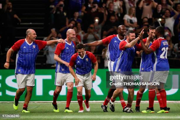 France 98's players celebrate after Zinedine Zidane scored a goal during an exhibition football match between France's 1998 World Cup's French...