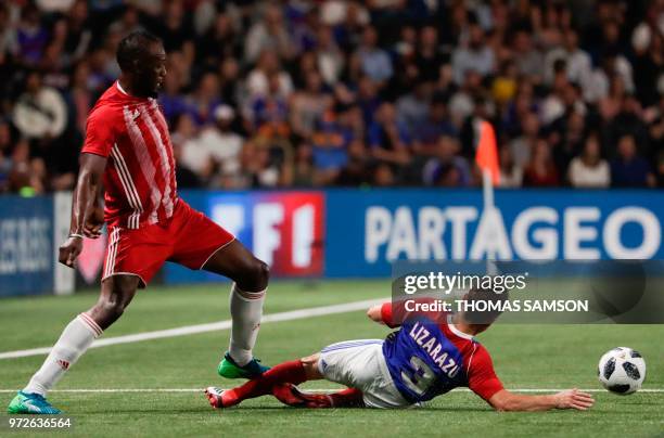 Fifa 98's Usain Bolt is tackled by France 98's defender Bixente Lizarazu during an exhibition football match between France's 1998 World Cup's French...