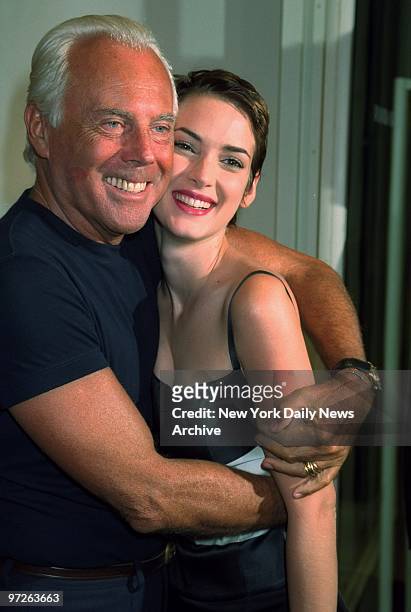 Fashion designer Georgio Armani hugs Winona Ryder during a party he hosted for the opening of his new store on Madison Ave.
