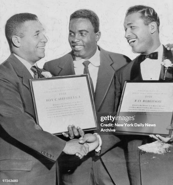 Roy Campanella and Ray Robinson receive awards from Jackie Robinson.