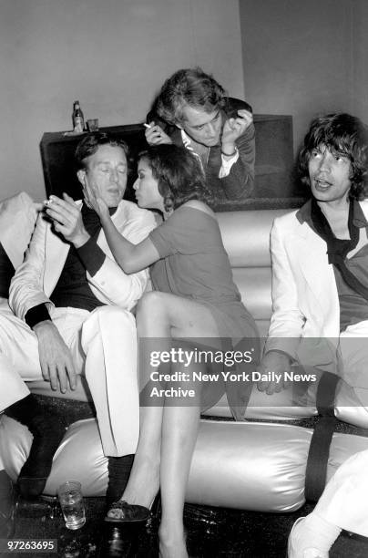 Fashion designer Halston is comforted by Bianca Jagger as husband Mick looks on at birthday bash for Bianca at Studio 54.