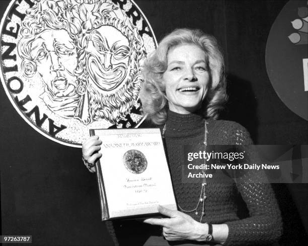 Lauren Bacall holding Tony Awards nominee plaque at Sardi's.