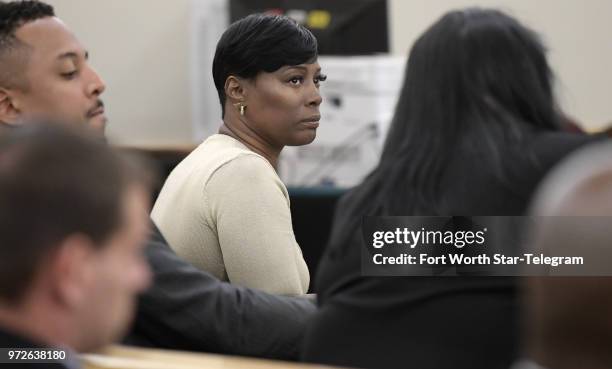 Crystal Mason, middle, convicted for illegal voting and sentenced to five years in prison, sitting at the defense table in Ruben Gonzalez's court at...