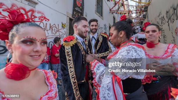 Dancers of Marcha de Bica are seen dressed in costume in the old quarter of Bica before leaving to parade in Avenida da Liberdade on June 12, 2018 in...