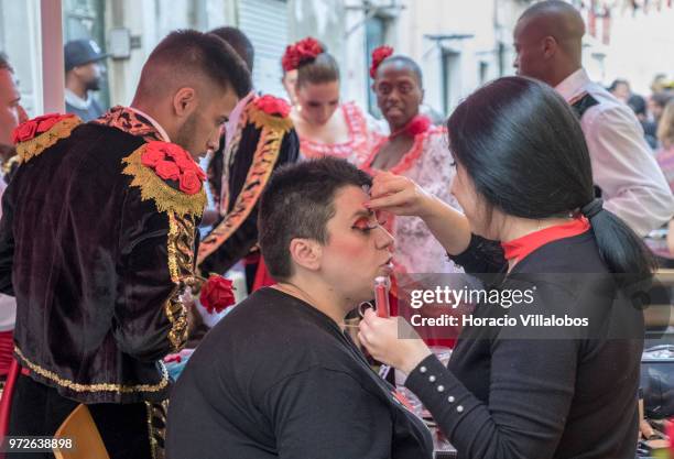 Dancers of Marcha de Bica are seen dressed in costume during a make-up session in the old quarter of Bica on June 12, 2018 in Lisbon, Portugal. Bica...