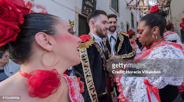Dancers of Marcha de Bica are seen dressed in costume in the old quarter of Bica before leaving to parade in Avenida da Liberdade on June 12, 2018 in...