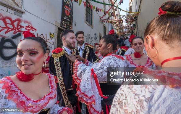 Dancers of Marcha de Bica are seen dressed in costume in the old quarter of Bica before leaving to parade in Avenida da Liberdade on June 12, 2018 in...