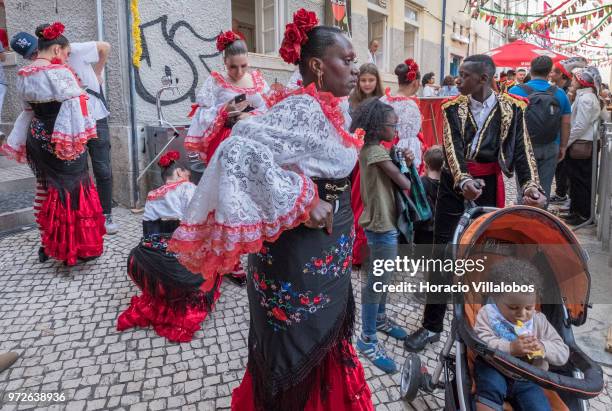 Dancers of Marcha de Bica are seen dressed in costume in the old quarter of Bica before leaving to parade in Avenida da Liberdade on June 12, 2018 in...