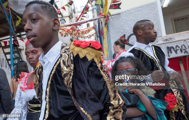 Dancers of Marcha de Bica are seen dressed in costume in the old quarter of Bica before leaving to parade in Avenida da Liberdade on June 12, 2018 in...