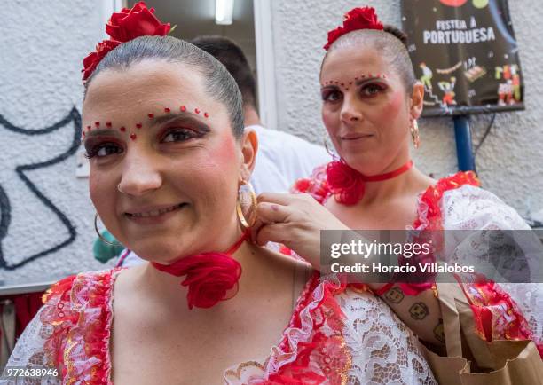 Dancers of Marcha de Bica are seen dressed in costume in the old quarter of Bica before leaving to parade in Avenida da Liberdade on June 12, 2018 in...