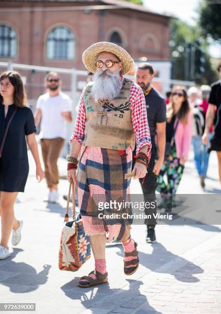 Guest with white beard wearing vest, hat is seen during the 94th Pitti Immagine Uomo on June 12, 2018 in Florence, Italy
