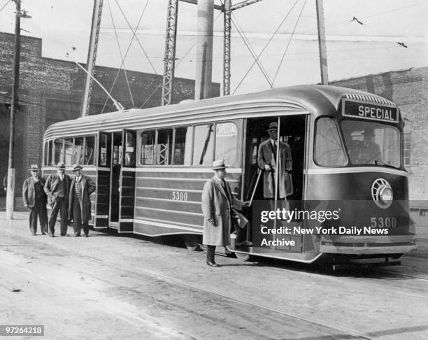 Officials look at "million dollar" streamlined trolley, at DeKalb and Seneca Avenues, before it takes it's trial run.