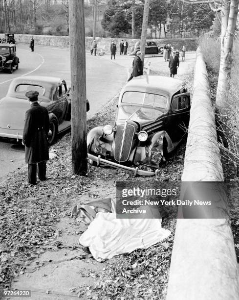 Fatal accident showing Magistrate Henry W. Bridges' car stopped between telegraph pole and stone wall at Moravian Cemetary in New Dorp, S.I. The body...