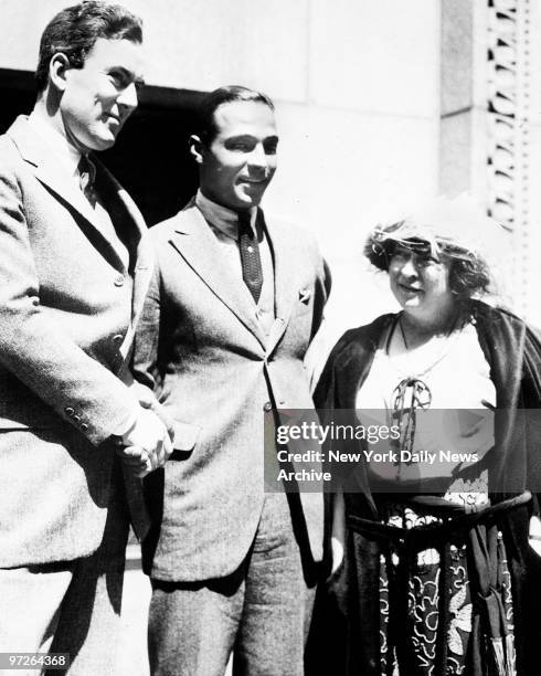 Rudolph Valentino, the screen's greatest lover, arrested for bigamy, stands outside the court house in Los Angeles, California. He is charged with...