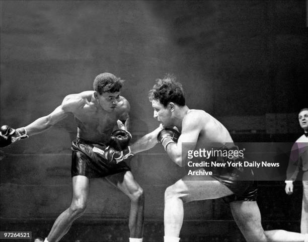 In second round at the Garden, Sugar Ray Robinson winds up with a mighty haymaker to throw at Jake Lamotta. Ray won the ten-rounder unanimously.