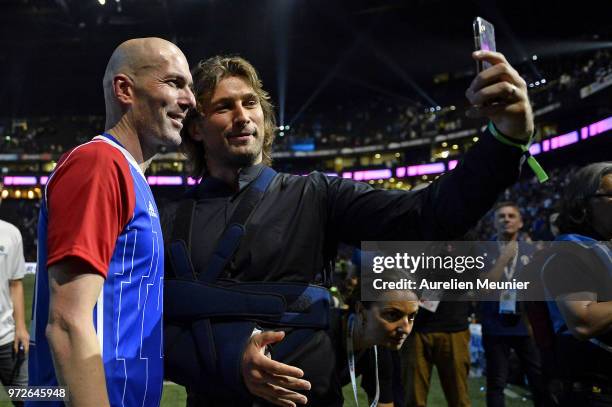 Zinedine Zidane of France 98 and Dimitri Szarzewski take a selfie after the friendly match between France 98 and FIFA 98 at U Arena on June 12, 2018...