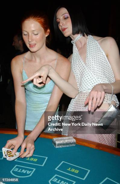Model Maggie Rizer gets some pointers on how to play her cards from fellow mannequin Erin O'Connor at a benefit Rizer is hosting for Design...
