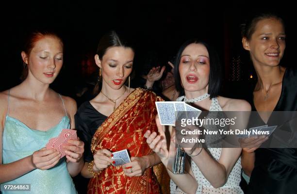Model Maggie Rizer reads the cards with fellow models Audrey Marnay, Erin O'Connor and Carmen Kass at a benefit Rizer is hosting for Design...