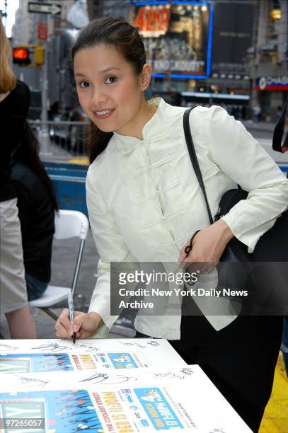 Lea Salonga signs a poster in Times Square where she joined other stars taking part in the annual "Broadway on Broadway" concert to kick off the new...