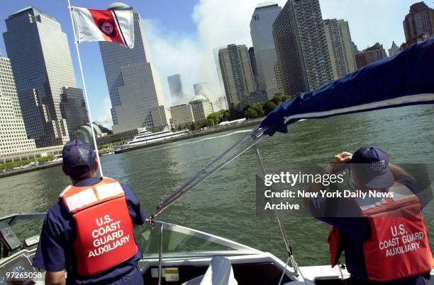 Coast Guard Auxiliarymen John Hood and Joe Curto keep watch on the waters around Manhattan on the fifth day following the terrorist attack that...